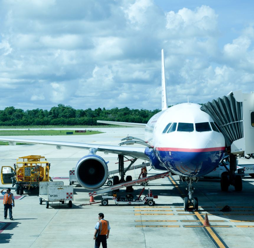 Plane loading with luggage at Cancun airport