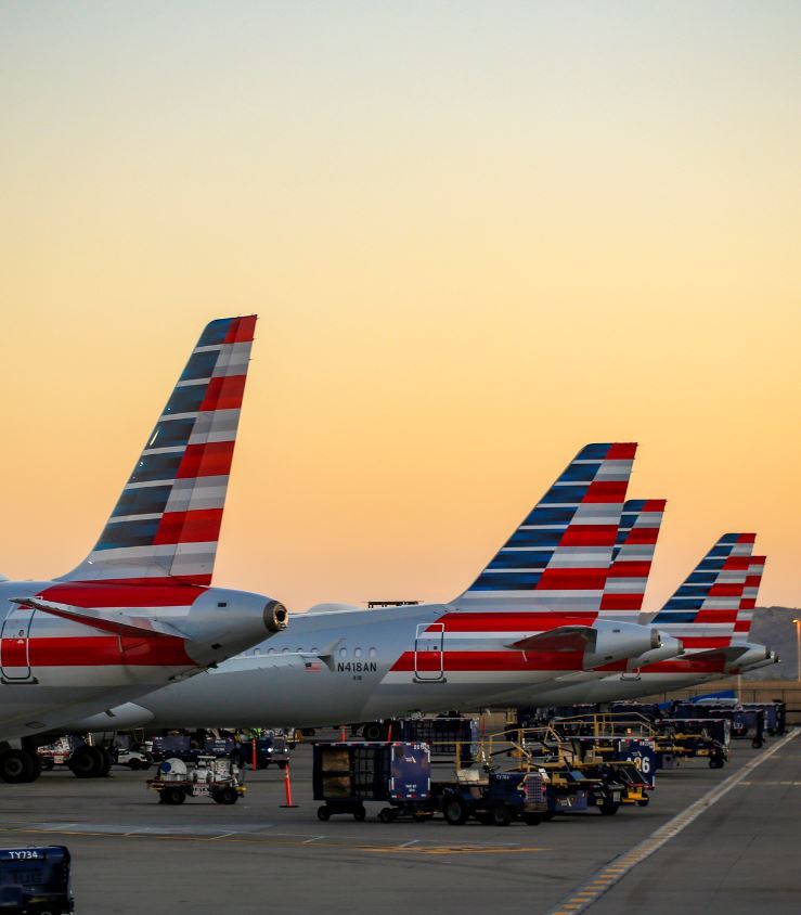 fleet of American airline planes at sunset 
