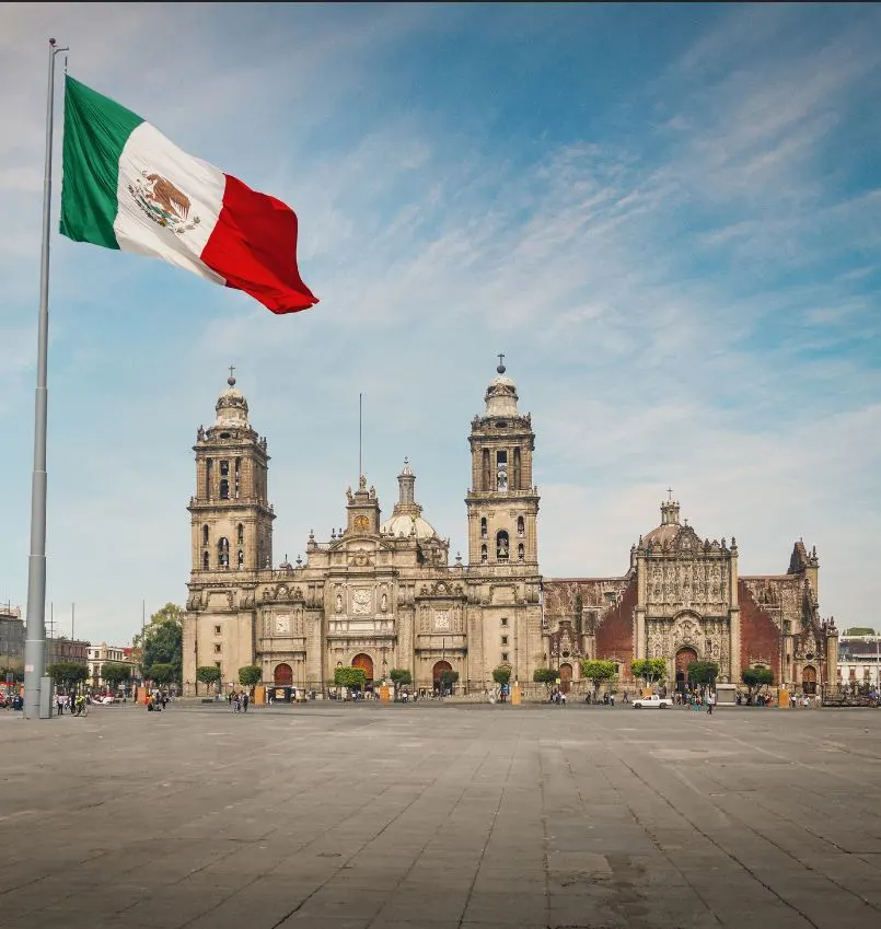 mexico city with mexico flag in foreground