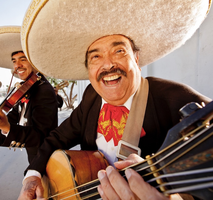 A smiling mariachi band member