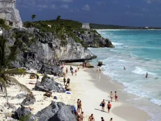 tourists enjoy Maya Ruins Tulum beach