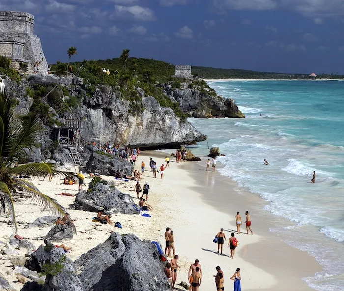 tourists enjoy Maya Ruins Tulum beach