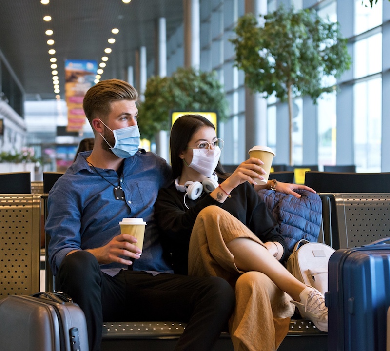 travelers at airport masks