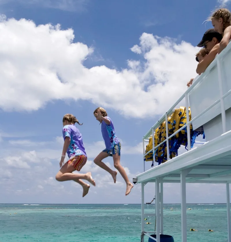 tourists jumping in cancun waters