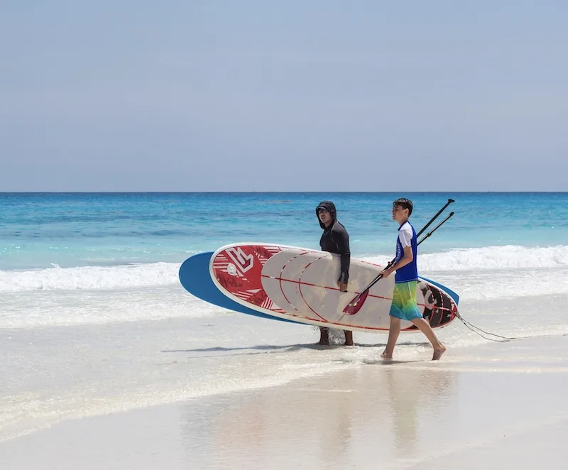 tourists surfing in Cancun