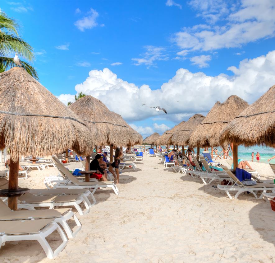 Lounge chairs and umbrellas on cancun beach 
