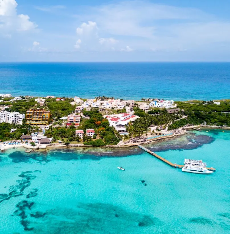 Beautiful island of Isla Mujeres and a boat at the pier.