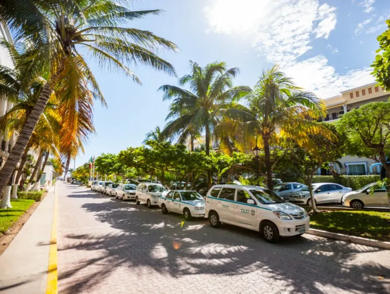 taxis lined up in a row outside on the streets of Playa del Carmen, Mexico