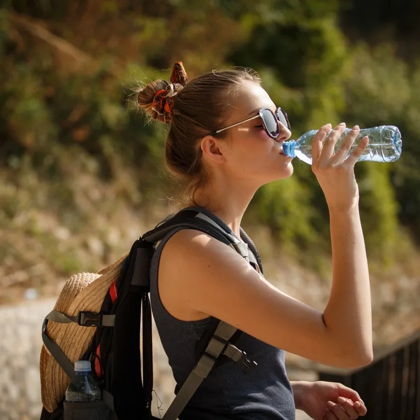 Woman drinking water outdoors