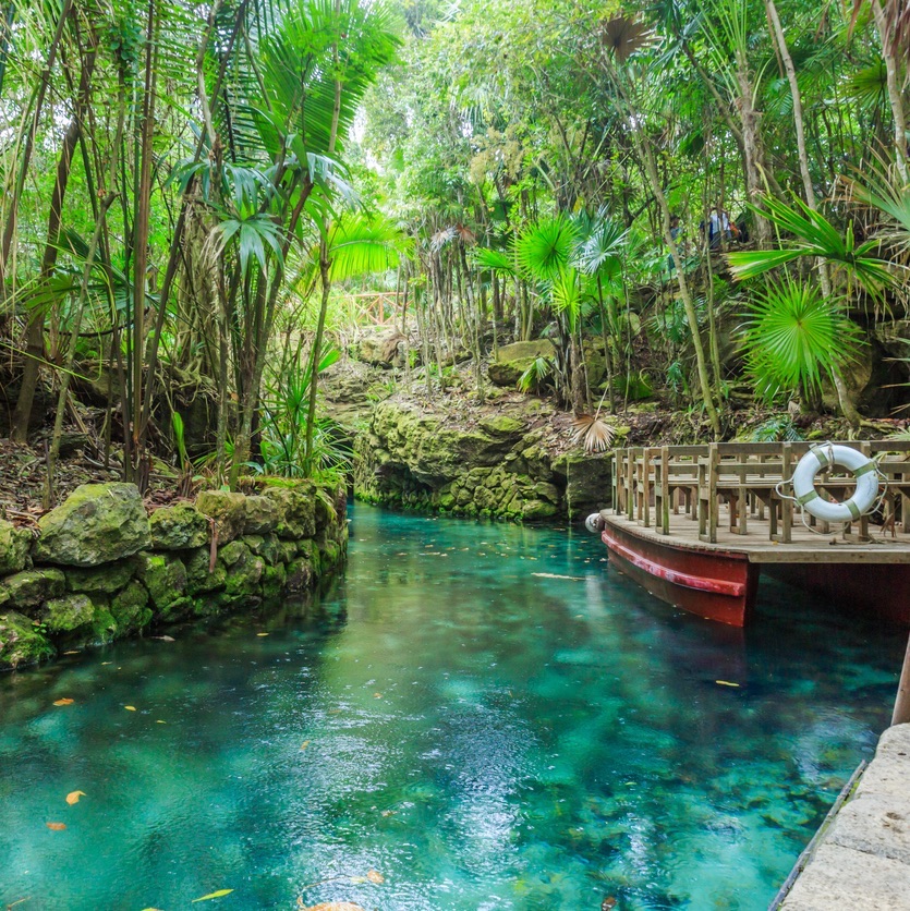 Small river arounded with the rocks in park Xcaret, Mexico