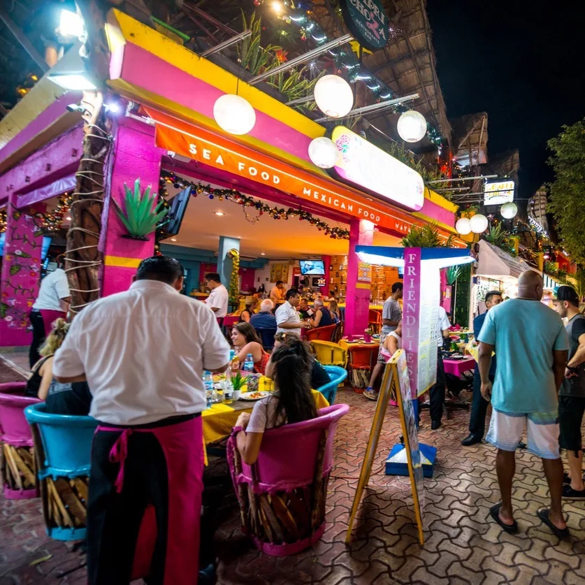 Server serving customers at a Mexican Restaurant on Playa del Carmen's famous 5th avenue.