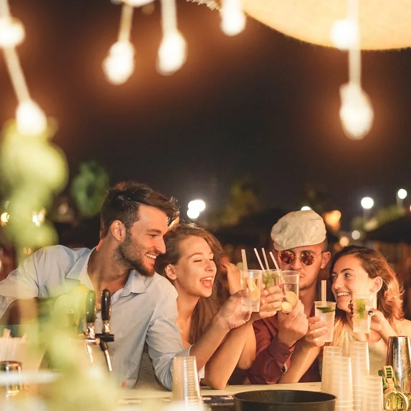 Travelers toasting cocktails at a resort bar