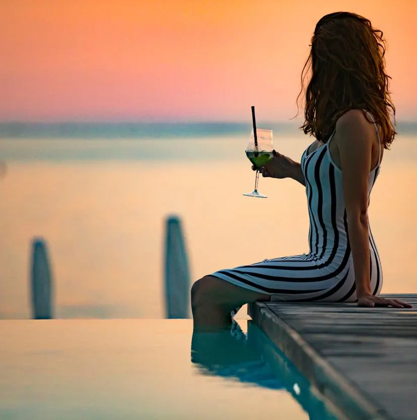 Woman At beach club with cocktail