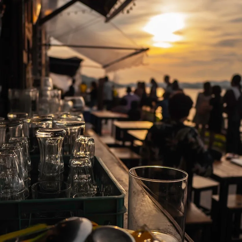 empty glass on bar at sunset