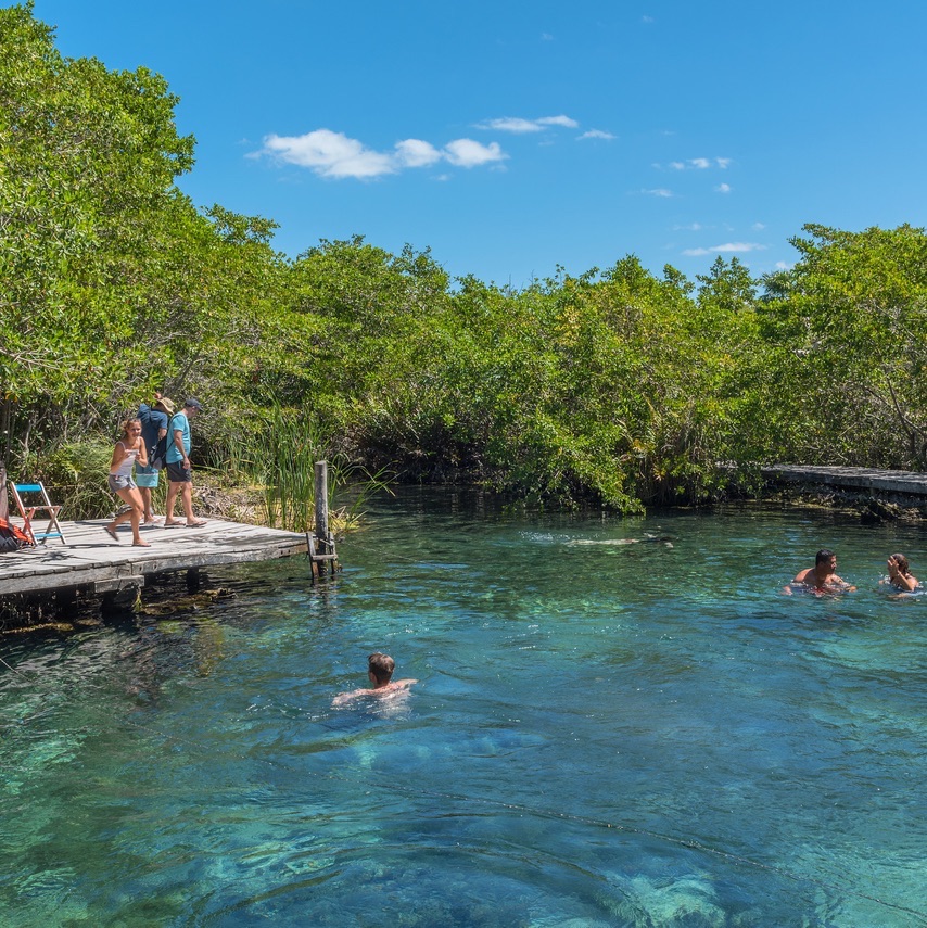 Tourists swim at the Hoyo negro Yalahau water hole, Isla Holbox, Mexico