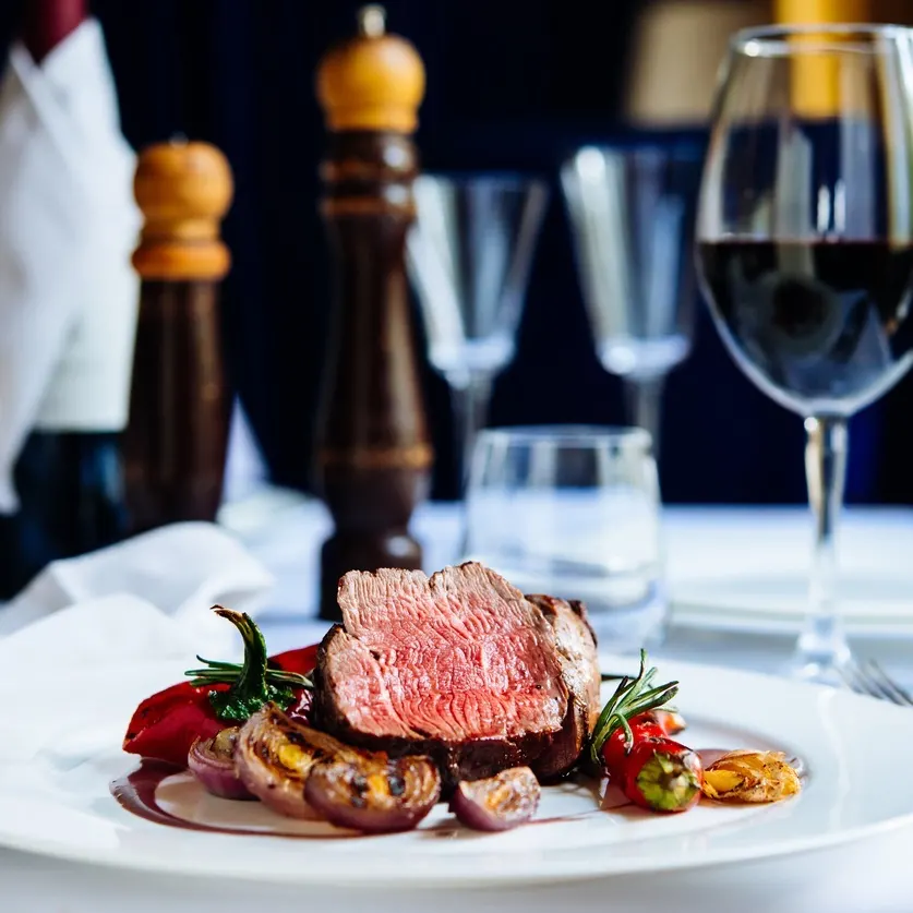 Beef steak with grilled vegetables served on white plate