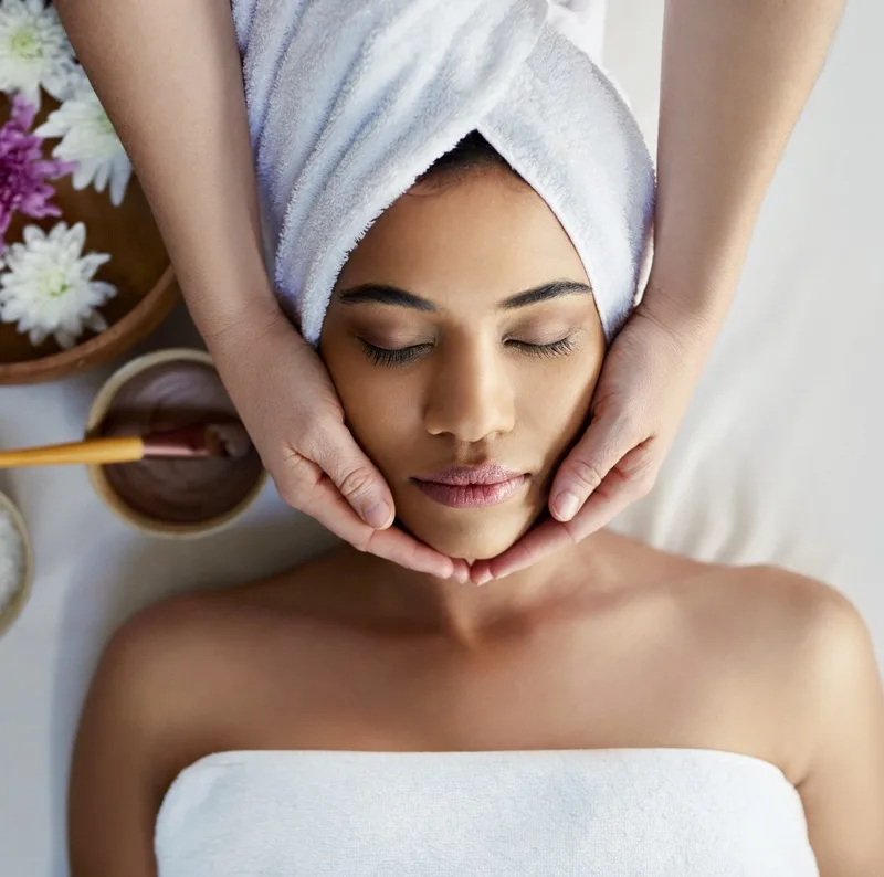 Shot of a young woman getting a facial treatment at a spa