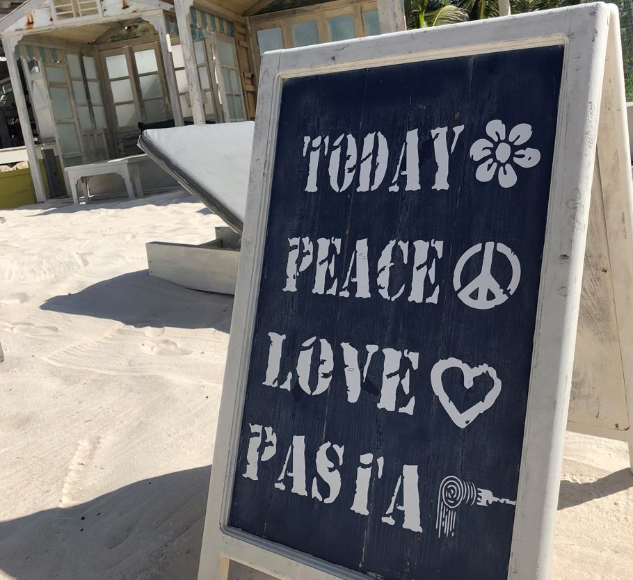 Peave love pasta sign on beach in tulum