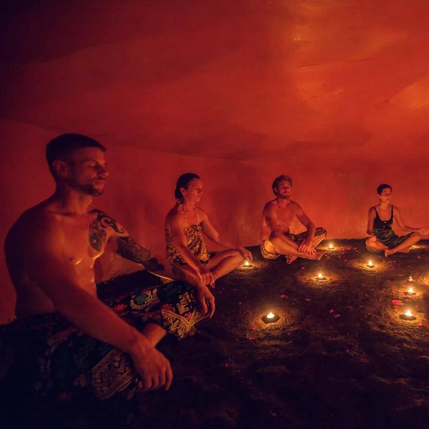 people meditating in cave