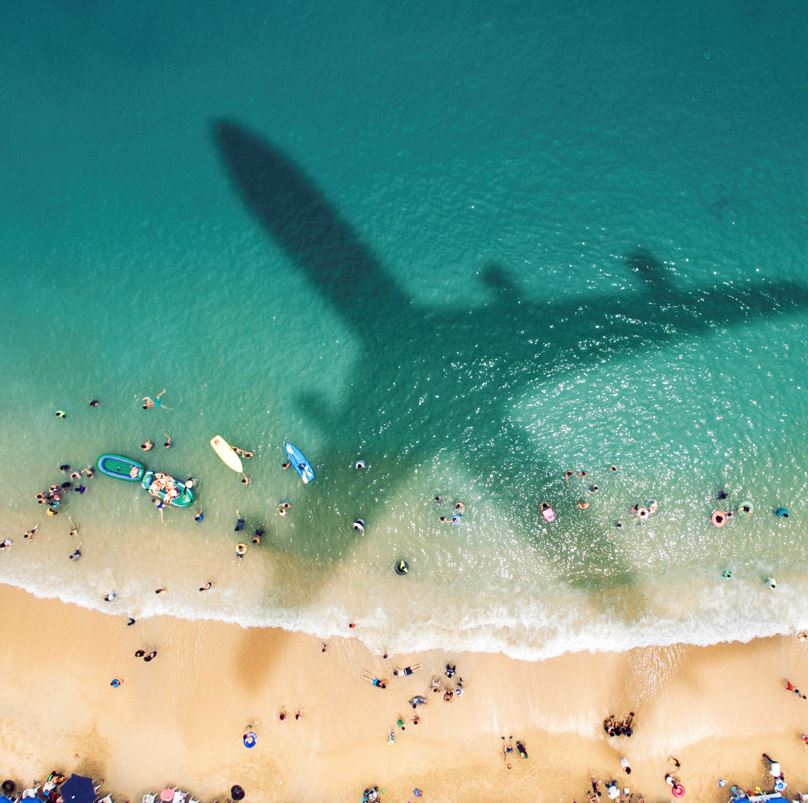 shadow of a plane flying over the beach in Cancun, Mexico.