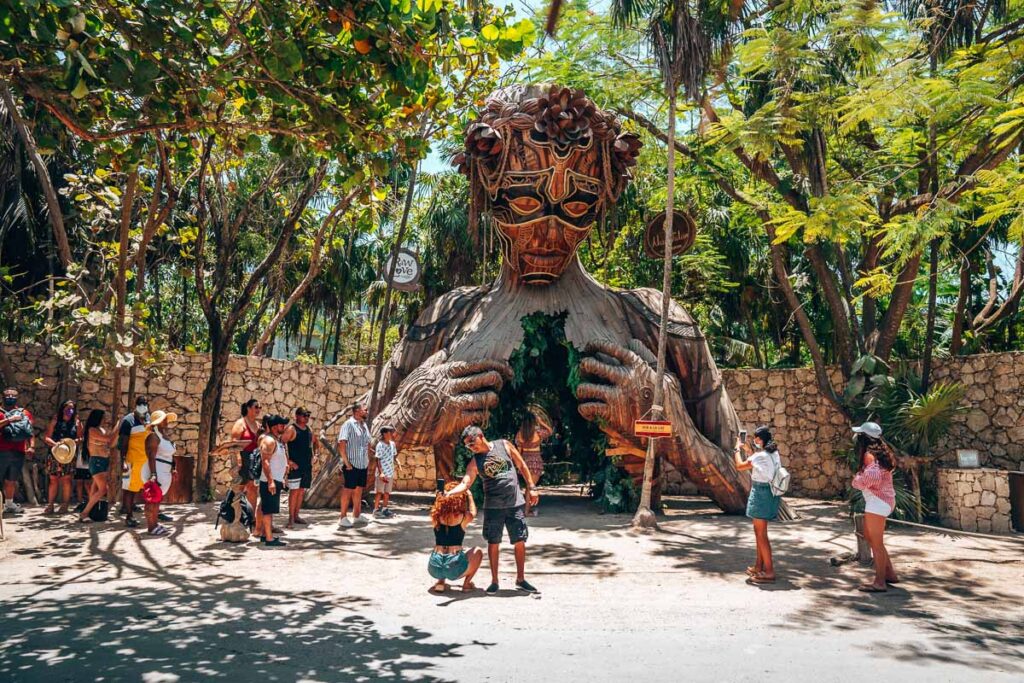 Tulum Statue with Tourists In Front of It