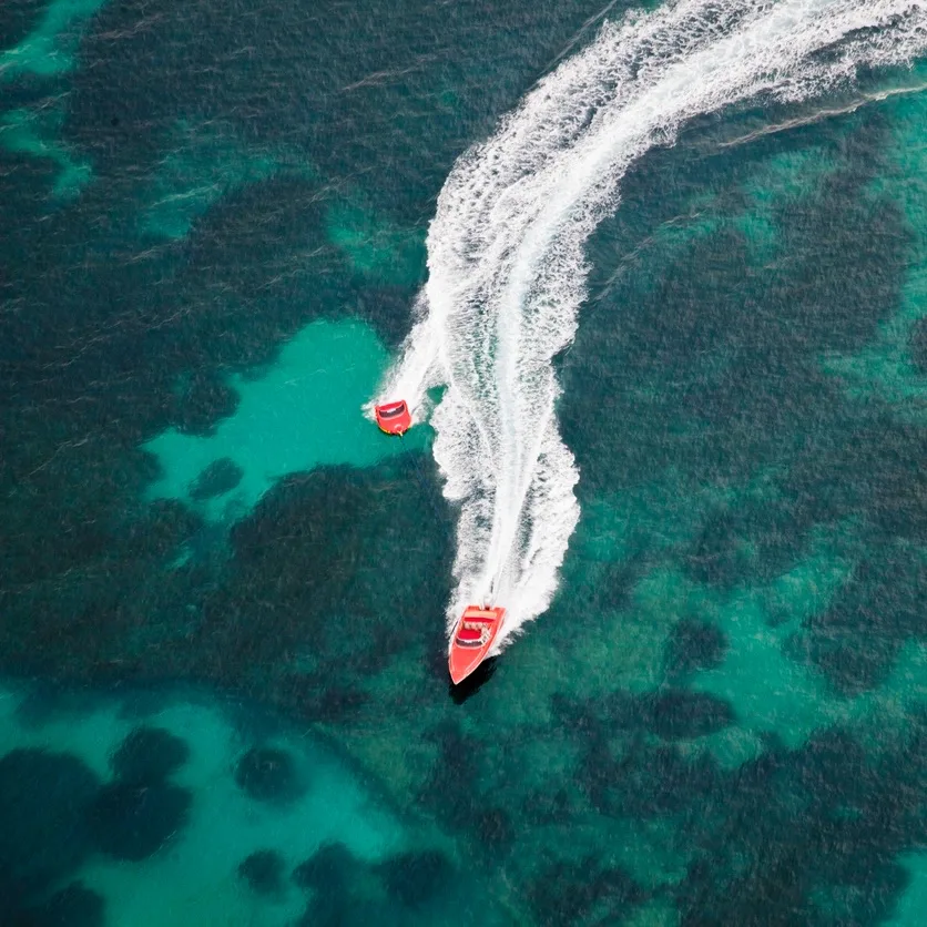 Speed boats in the turquoise blue water in Cancun.