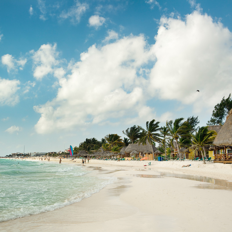 Beach resort hotels and beach chairs along the Caribbean beach of Playa del Carmen, along the Riviera Maya near Cancun, Mexico.