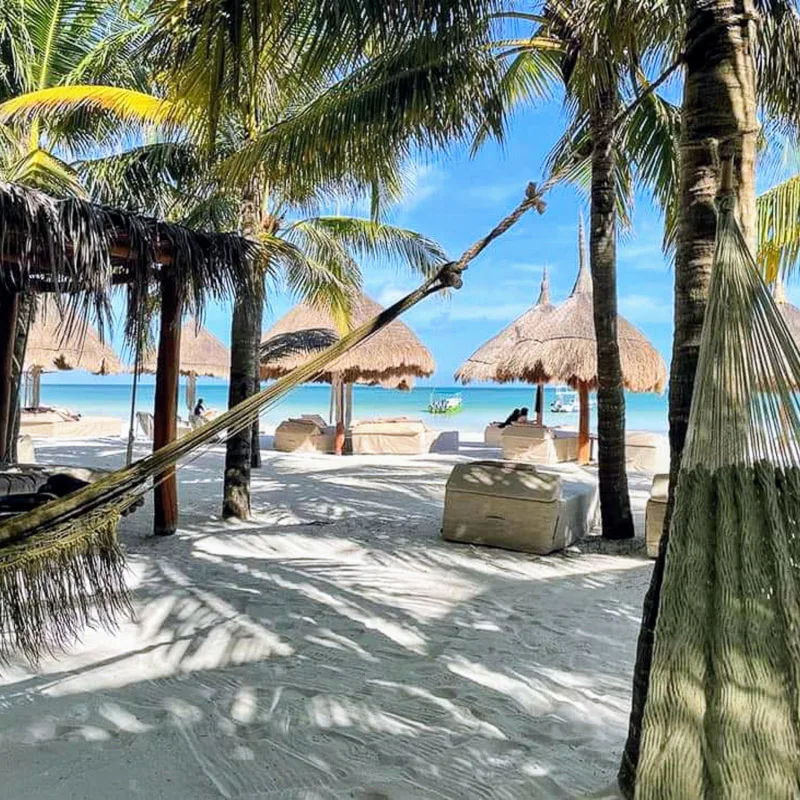 Beach in Holbox with hammocks and ocean views.