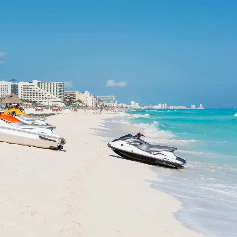 beach cancun with jet skis on the sand