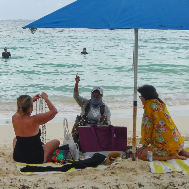 masked woman on beach