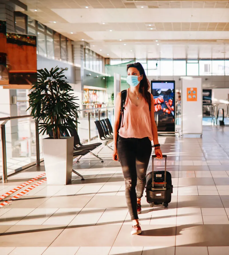 Young lady wearing mask at airport 