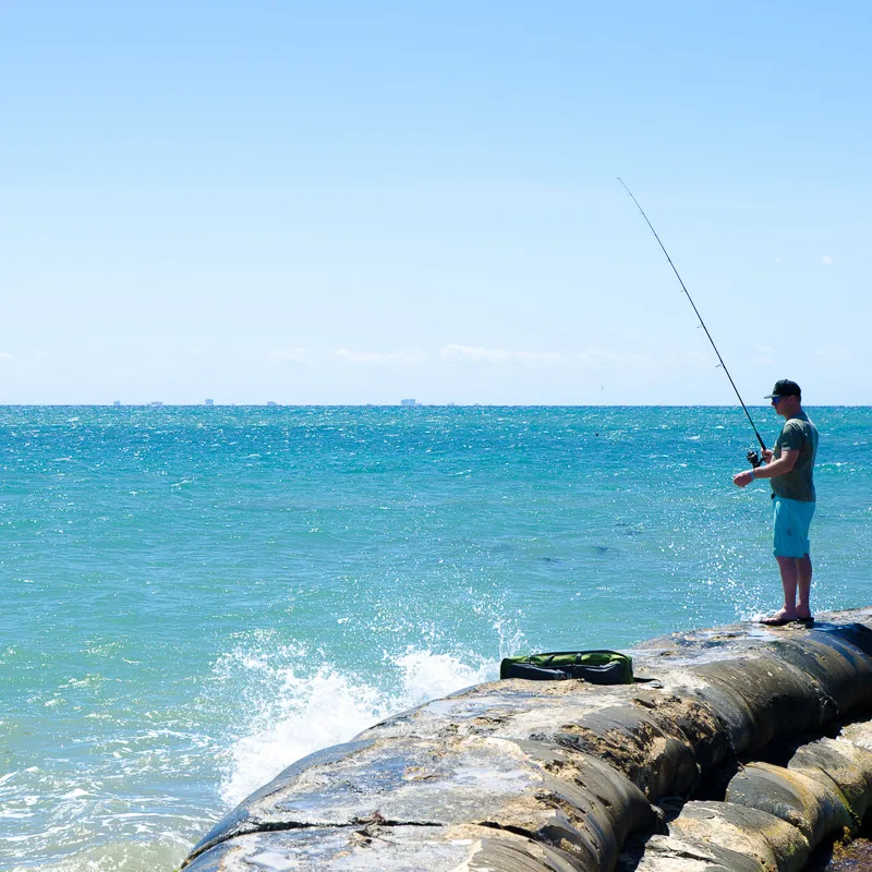 man fishing in playa del carmen