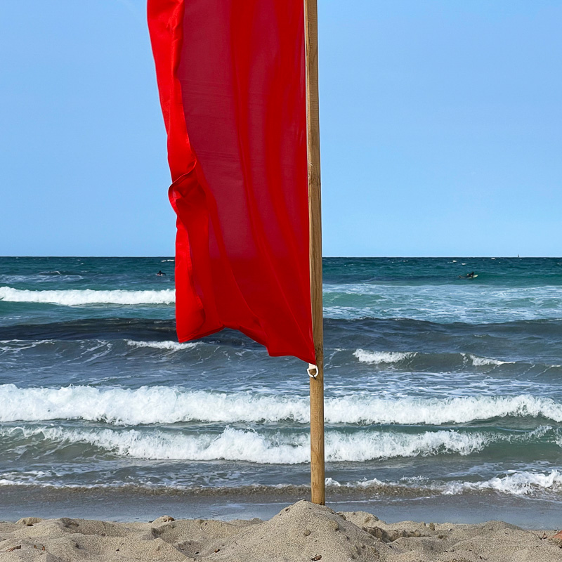 red flag in the sand