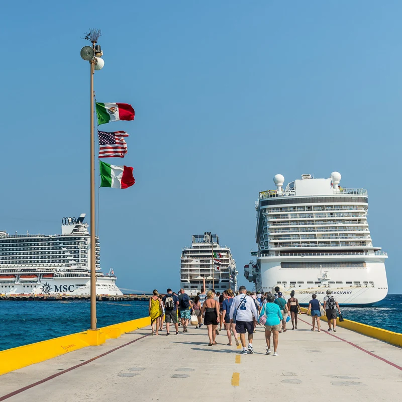 people walking towards ship