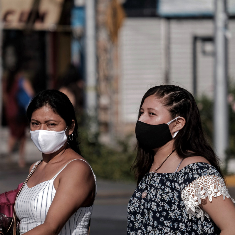 two girls with masks in cancun