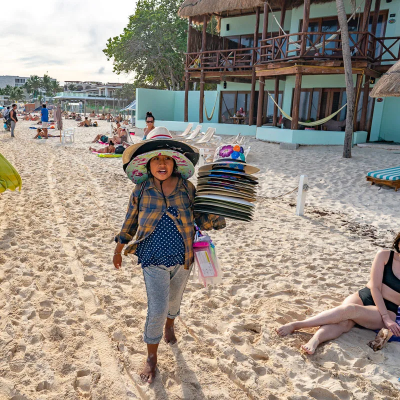 Vendor Selling Hats on a Beach