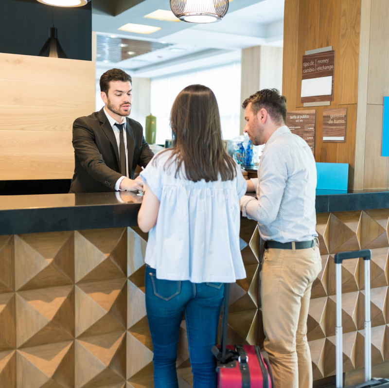 people checking in to a hotel