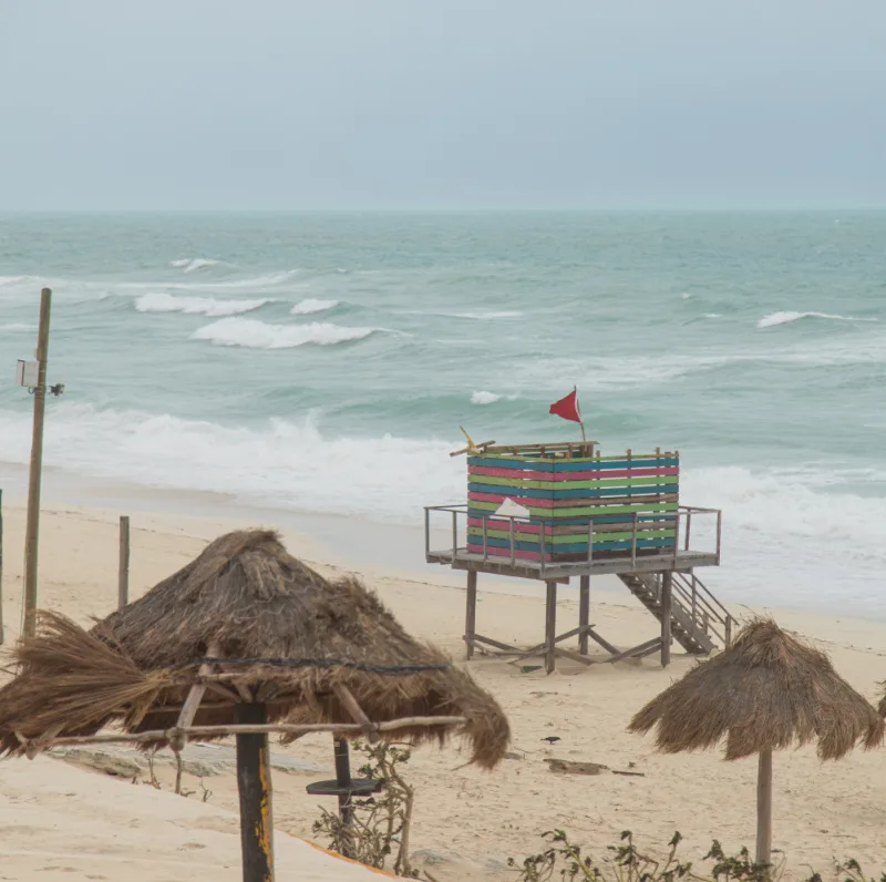 Red flag hurricane on beach 