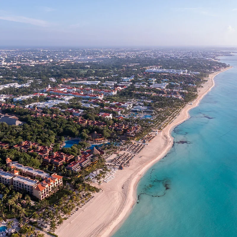 Cancun beach coastline with resorts lined up along the coast.