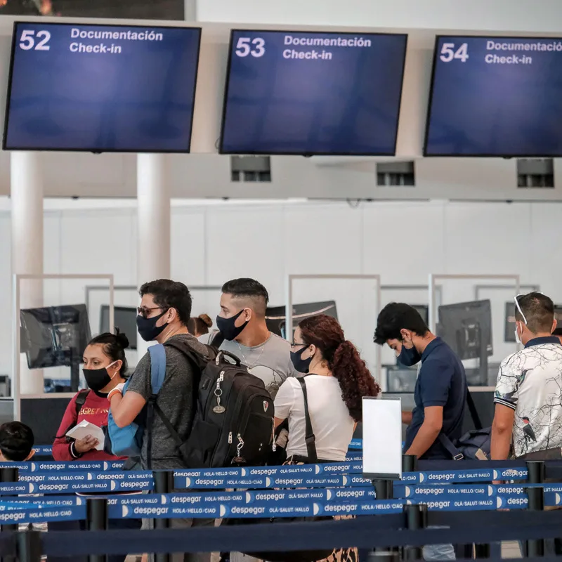 masked tourists at airport