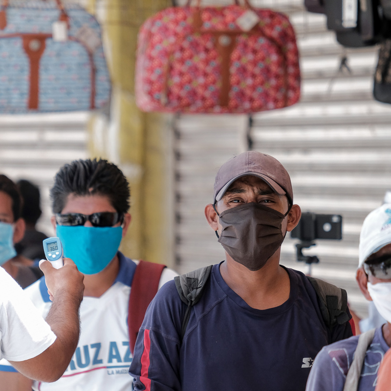 people waiting in line with masks on