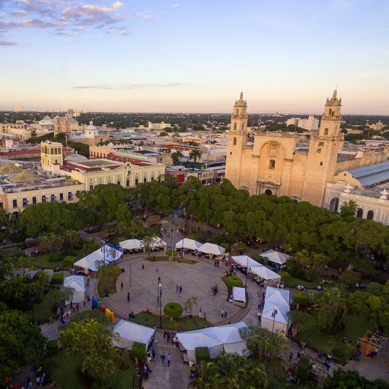 Merida town center with vendor tents everywhere and tourists standing around.