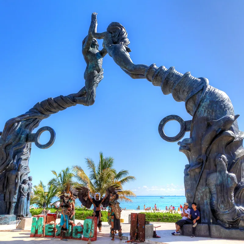 playa del carmen statue by the beach during the day.