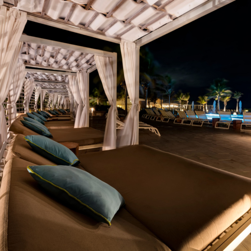 Palladium Resort lunge chairs by the pool for relaxing on a warm evening.