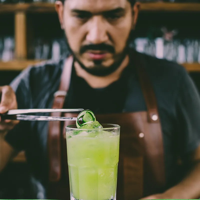 man prepares cocktail