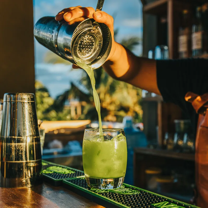 green cocktail on bar