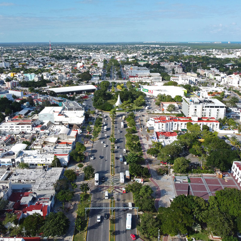 Downtown Cancun aerial shot with views of buildings and sea.