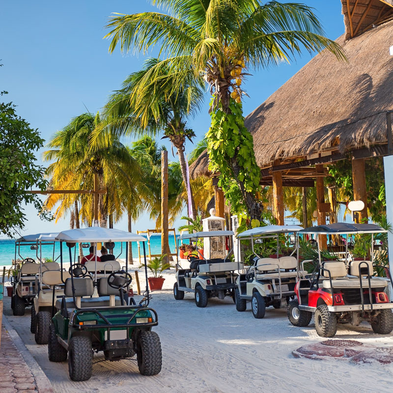 golf carts outside beach bar isla mujeres