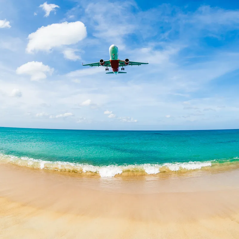 plane flying over cancun