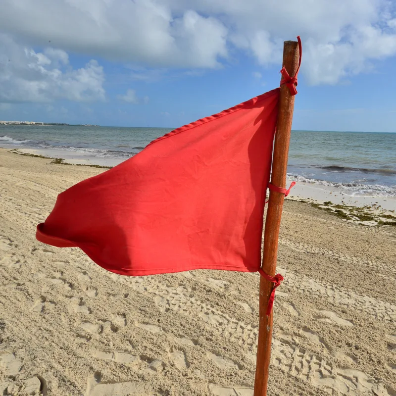 A red flag used to warn travellers about beach conditions in the Mexican Caribean